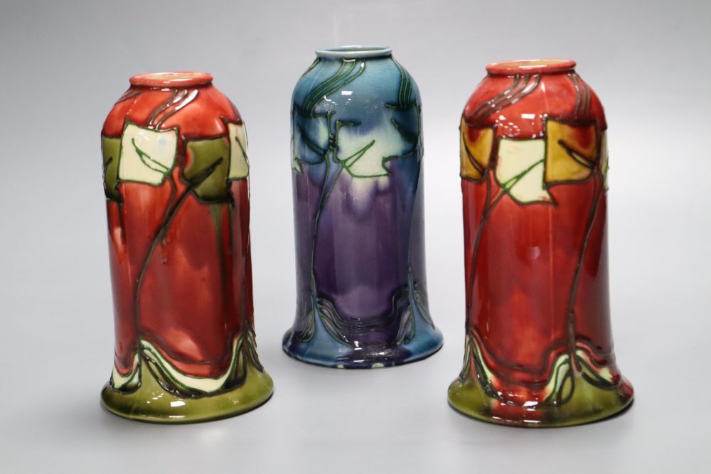 A pair of Minton Secessionist bell-shaped red ground vases (No 46) and a similar mauve-ground vase,